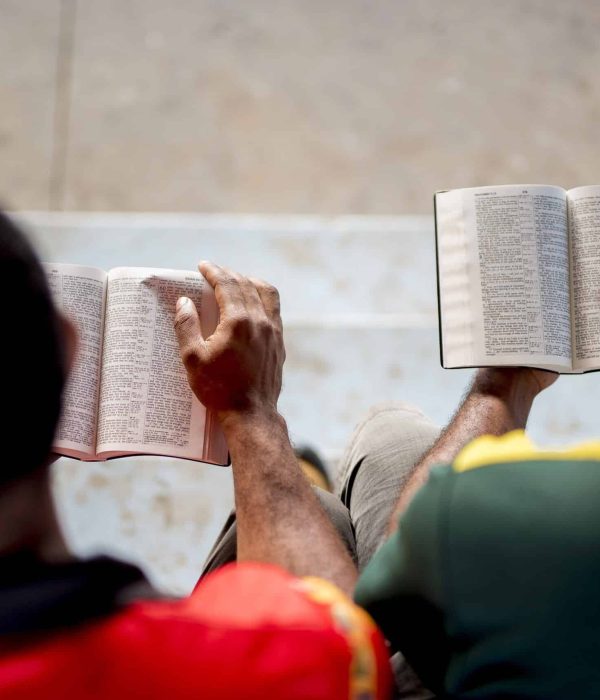 An overhead shot of people sitting and reading the bible with a blurred background